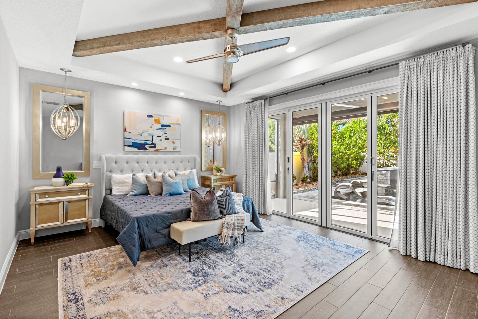 primary bedroom with large bed and sliding door to patio